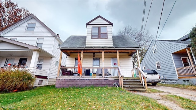 bungalow-style house with covered porch and a front yard