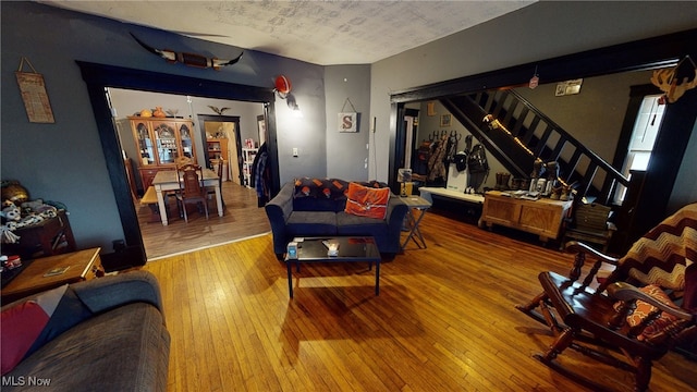 living room with hardwood / wood-style floors and a textured ceiling