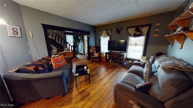 living room with hardwood / wood-style flooring and a textured ceiling