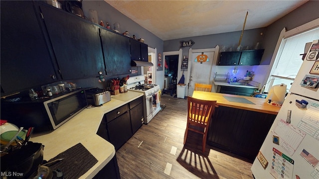 kitchen featuring white appliances and light hardwood / wood-style flooring