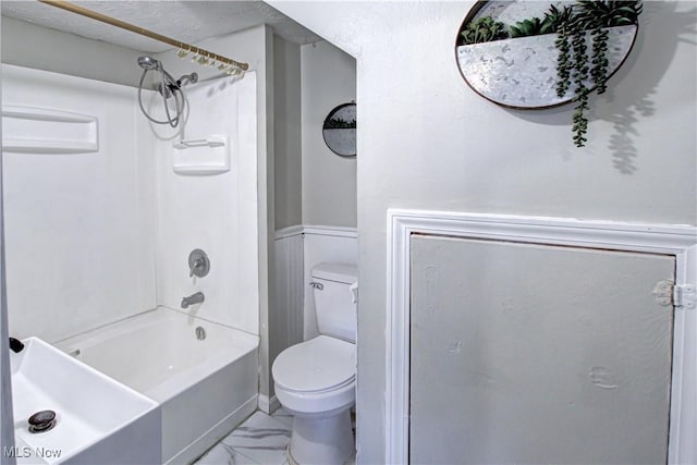 bathroom with toilet and bathing tub / shower combination