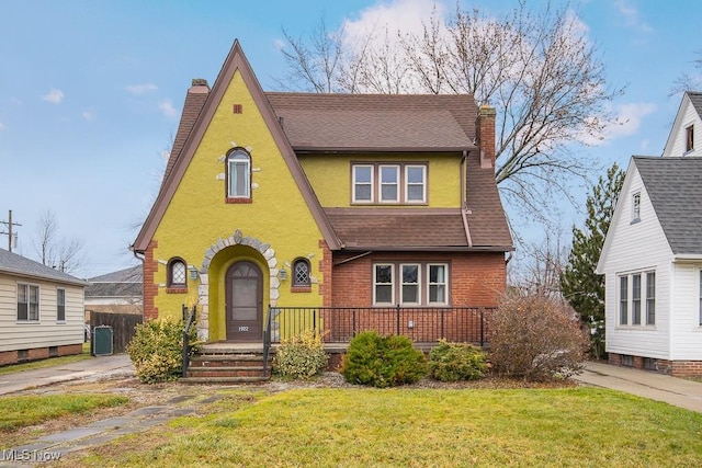 tudor home with central AC and a front lawn