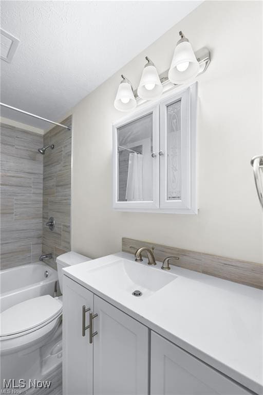 full bathroom featuring shower / bathtub combination with curtain, vanity, and toilet