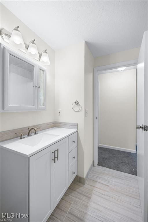 bathroom featuring vanity and a textured ceiling