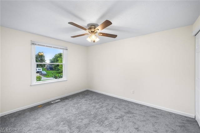 carpeted spare room with ceiling fan