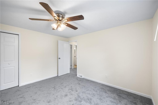 unfurnished bedroom featuring carpet flooring, a closet, and ceiling fan