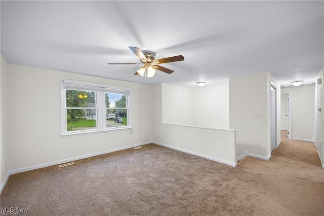 carpeted empty room with ceiling fan