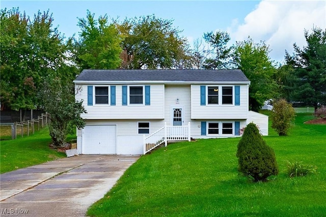 bi-level home featuring a front lawn and a garage