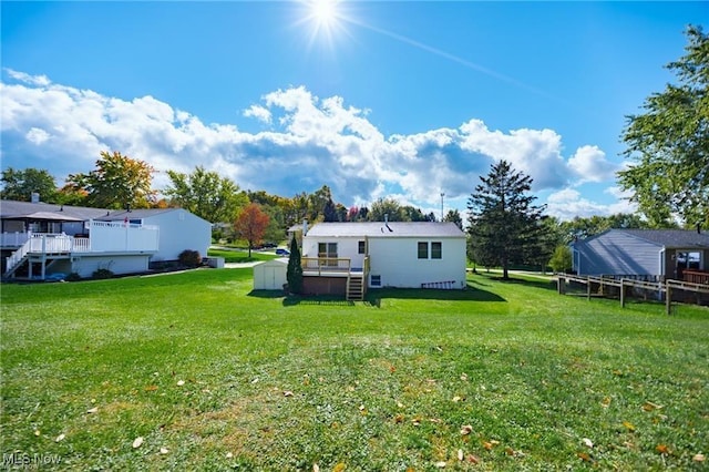 back of house with a yard and a deck