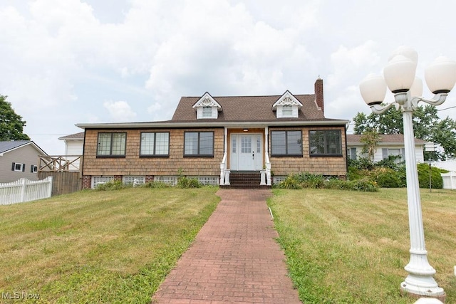 cape cod house with a front lawn