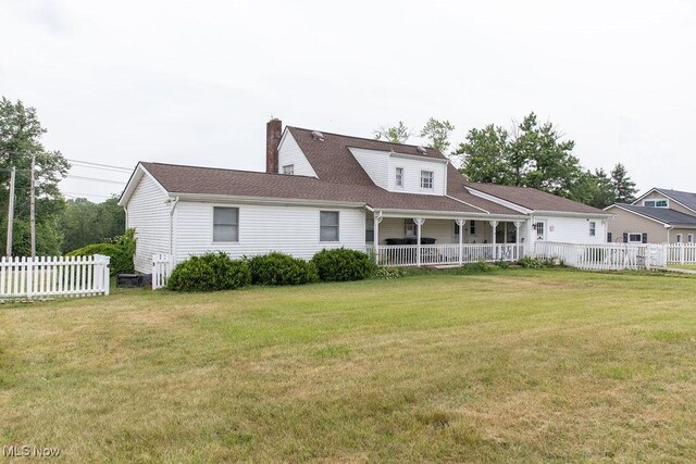 back of property featuring a yard