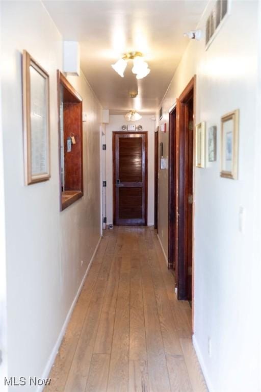 hall with light hardwood / wood-style floors