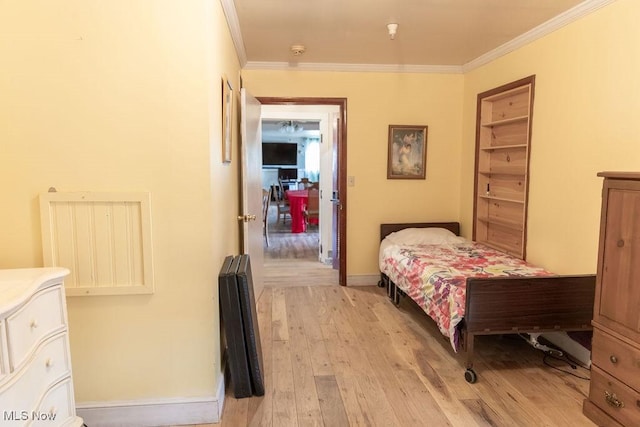 bedroom featuring light hardwood / wood-style flooring and ornamental molding