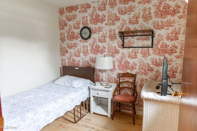 bedroom with hardwood / wood-style flooring