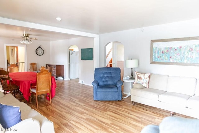 living room featuring ceiling fan and light hardwood / wood-style flooring