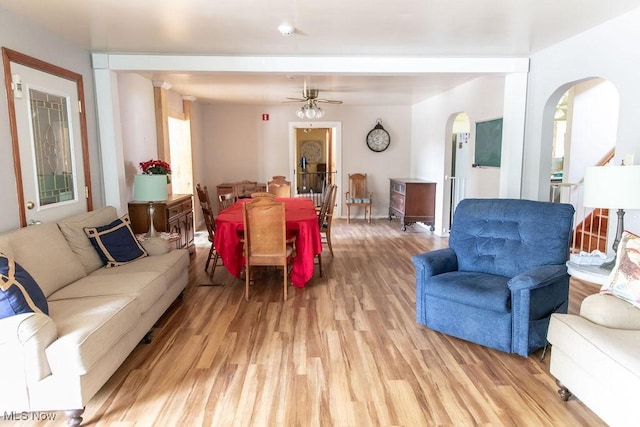 living room with light hardwood / wood-style floors and ceiling fan