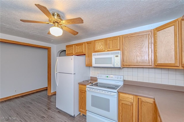 kitchen with backsplash, white appliances, a textured ceiling, ceiling fan, and wood-type flooring