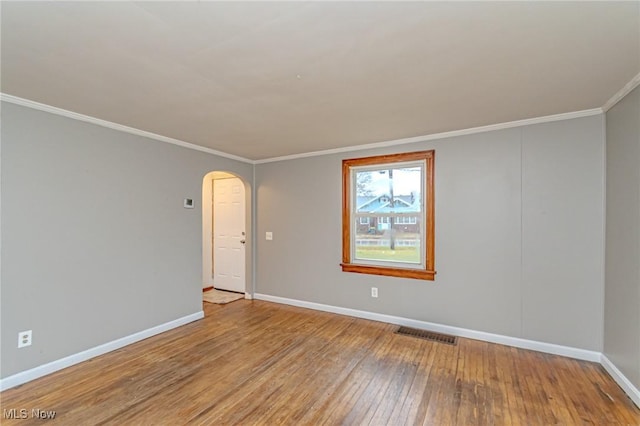 unfurnished room featuring light wood-type flooring and ornamental molding