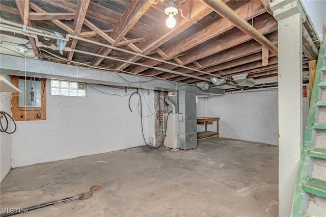 basement featuring electric panel and heating unit