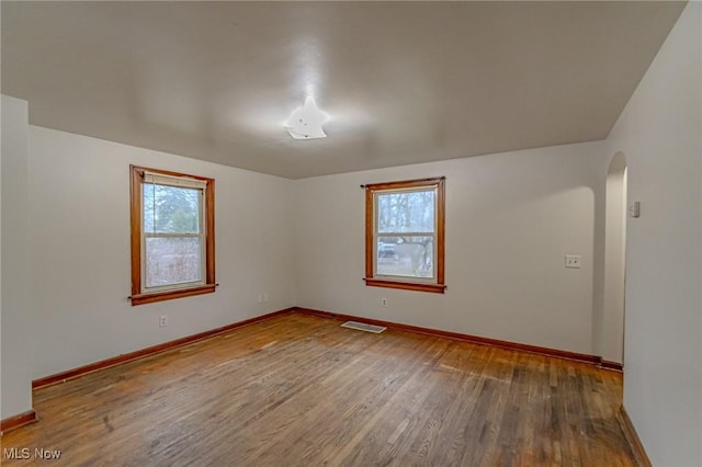 unfurnished room with wood-type flooring