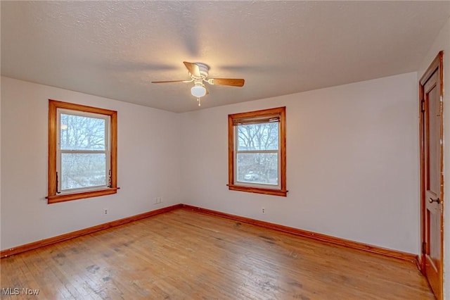 unfurnished room with light wood-type flooring and ceiling fan