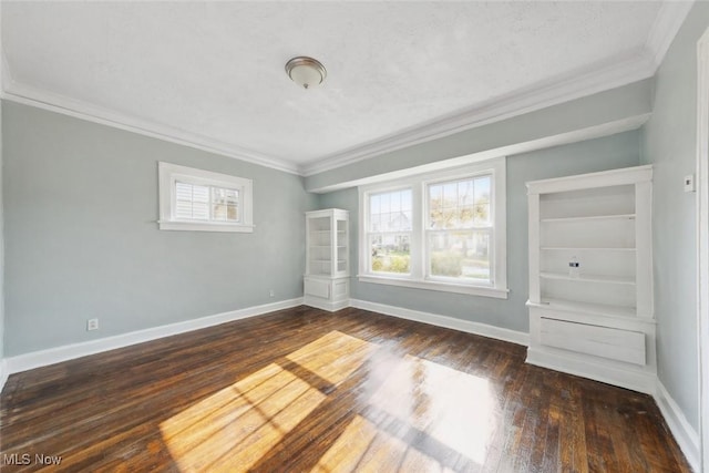 unfurnished bedroom with crown molding and dark wood-type flooring