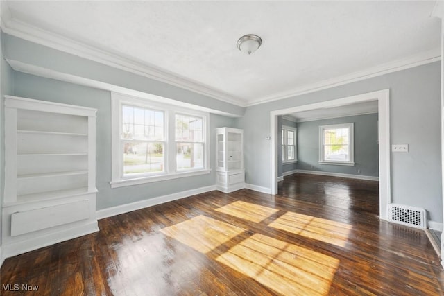 empty room with dark hardwood / wood-style flooring and ornamental molding