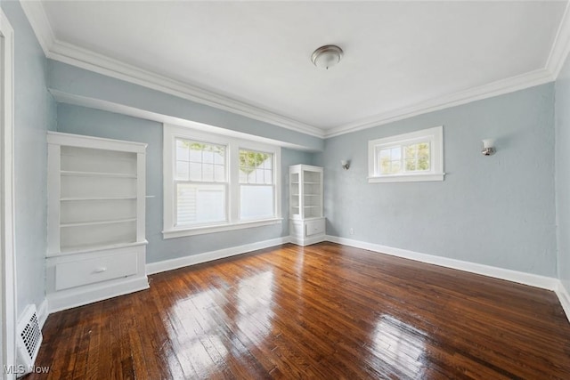 empty room featuring dark hardwood / wood-style flooring and crown molding