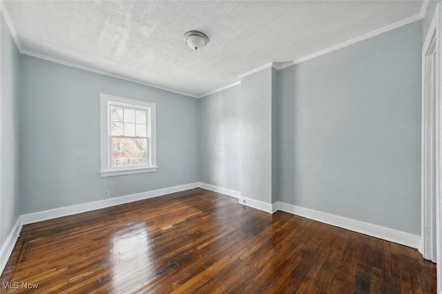 unfurnished room featuring a textured ceiling, ornamental molding, and dark wood-type flooring