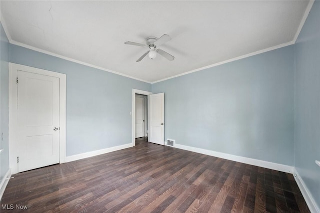 spare room with dark hardwood / wood-style floors, ceiling fan, and crown molding