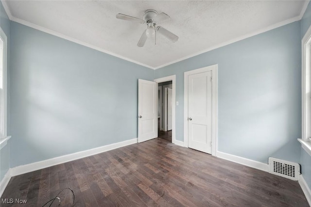 unfurnished bedroom with ceiling fan, dark hardwood / wood-style floors, and ornamental molding