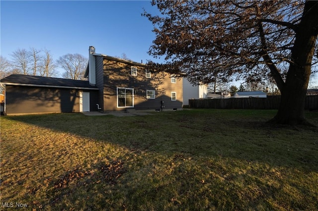 rear view of house with a lawn