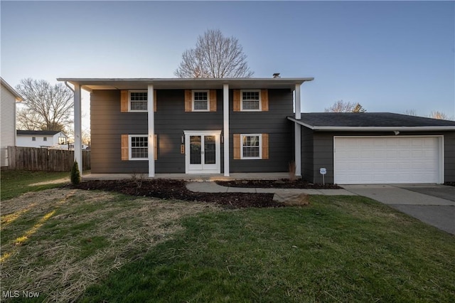 view of front facade with a front yard and a garage