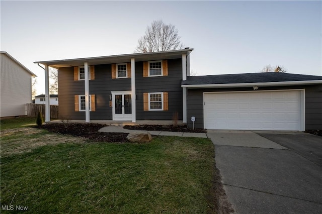 view of front of home with a garage and a front yard