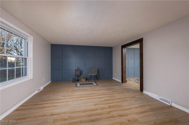 spare room with light wood-type flooring