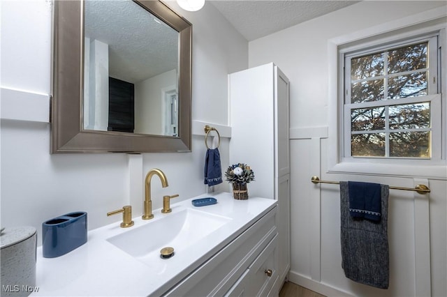 bathroom featuring vanity, a textured ceiling, and plenty of natural light