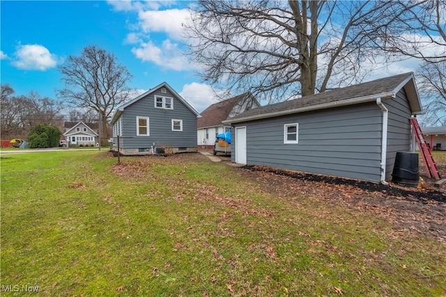 back of property with an outbuilding, cooling unit, and a yard