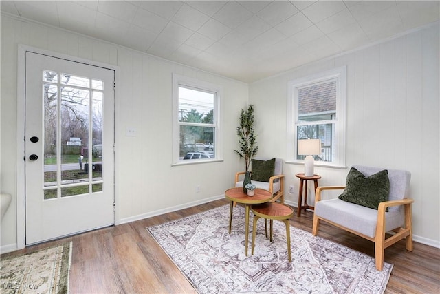 living area with plenty of natural light and hardwood / wood-style flooring