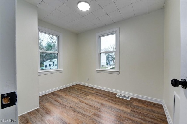 empty room with hardwood / wood-style floors