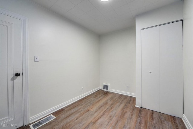 unfurnished bedroom featuring a closet and light hardwood / wood-style floors