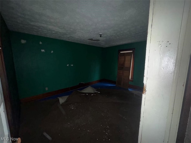 spare room featuring a textured ceiling