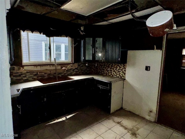 kitchen featuring backsplash and sink