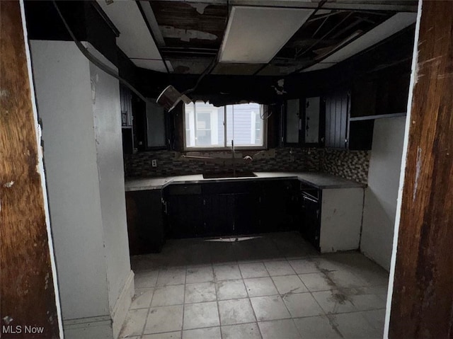 kitchen featuring tasteful backsplash and sink