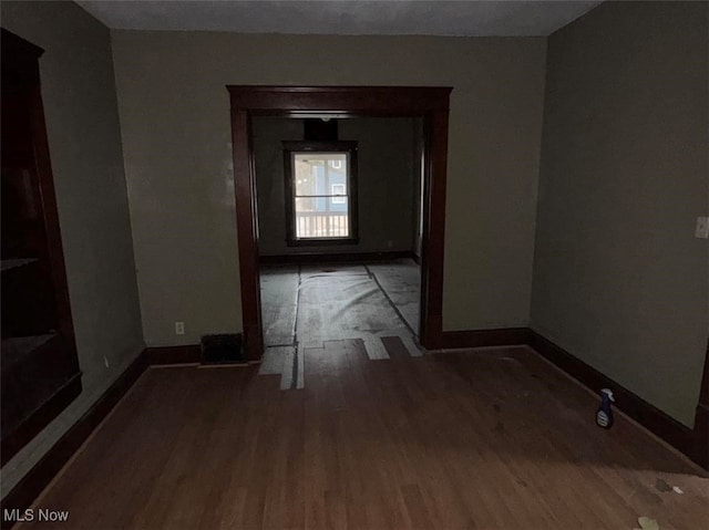 empty room featuring dark wood-type flooring