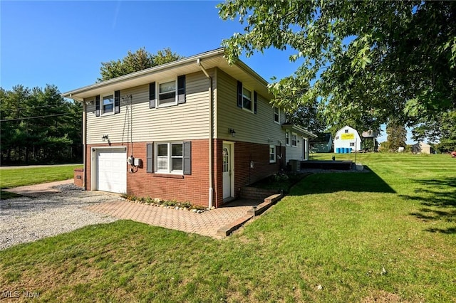 view of side of property with a yard and a garage