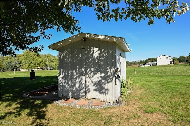 view of property exterior featuring a yard and a storage unit