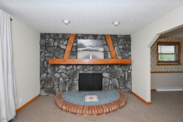 interior details featuring carpet flooring, a stone fireplace, a textured ceiling, and a baseboard radiator