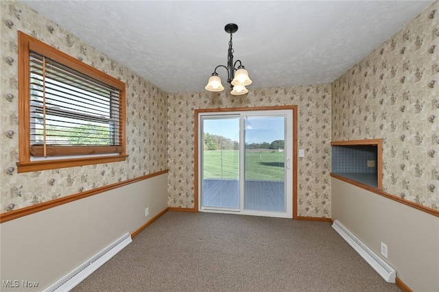 empty room with carpet floors, a baseboard radiator, and a notable chandelier