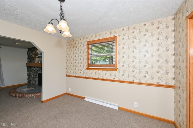 unfurnished living room featuring baseboard heating, carpet, a textured ceiling, and an inviting chandelier