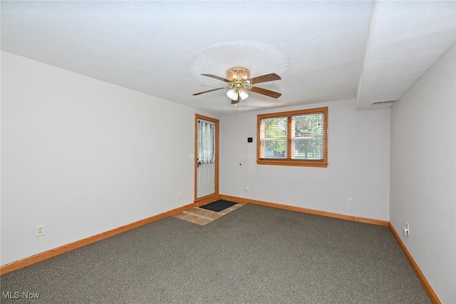 spare room featuring carpet and ceiling fan